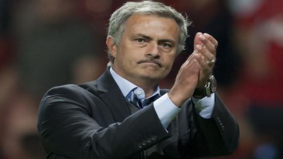 Chelsea's manager Jose Mourinho applauds supporters as he walks from the pitch after his team's 0-0 draw against Manchester United during their English Premier League soccer match at Old Trafford Stadium, Manchester, England, Monday Aug. 26, 2013. (AP Photo/Jon Super) Britain Soccer Premier League